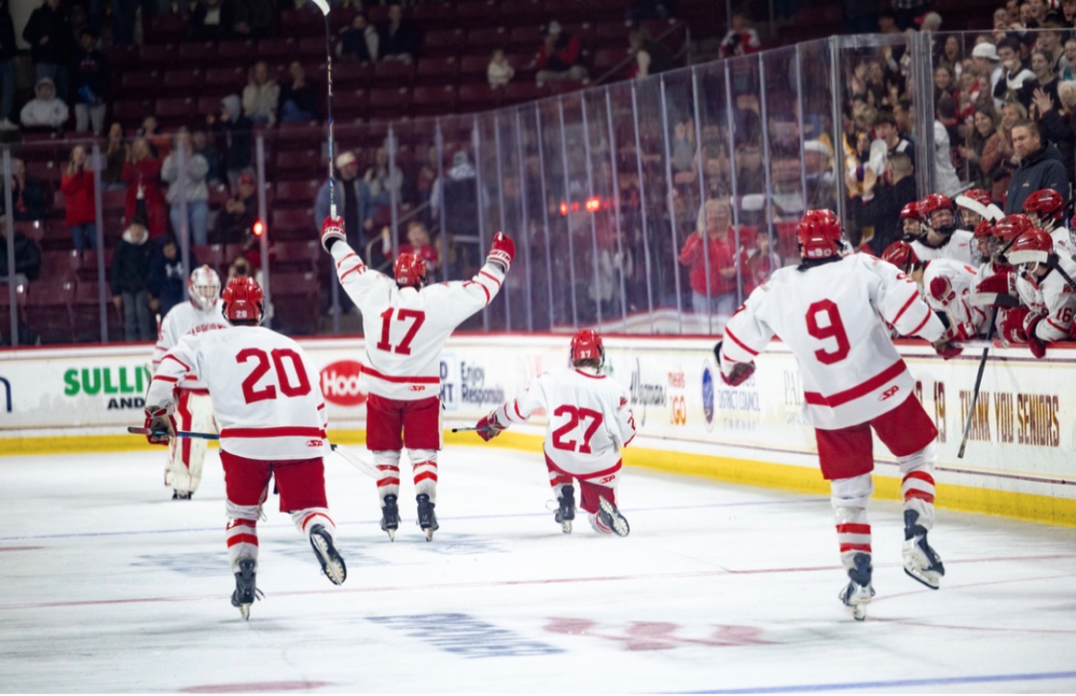 Quinn Allen (#27) Celebrates an early first period goal alongside teammates #20 Nick Bigelow, #17 Sean Caroll, and #9 Cam McKenna.