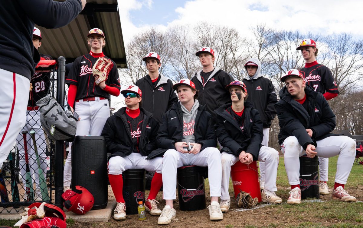 The starters turn to listen to their head coach, Nick DeVito.