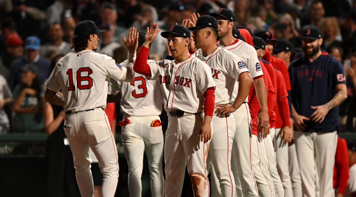 Red Sox players Jarren Durran (Left) and Masataka Yoshida (Right) high-five in joy as they get ready to play a big game against the New York Yankees.