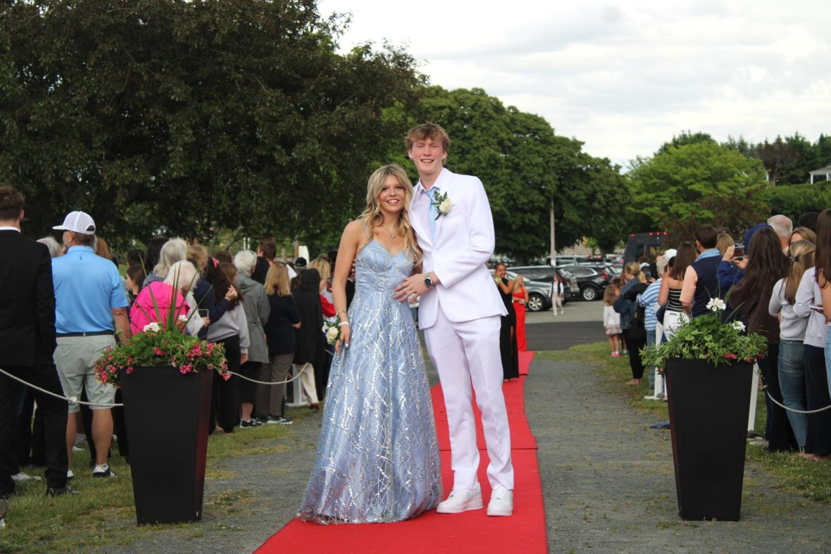 Senior Derek Ogar and his date walk the red carpet.