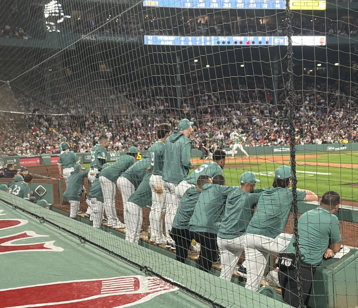 The Red Sox Bench looks on attentively as Carlos Narvaez digs into the batters box