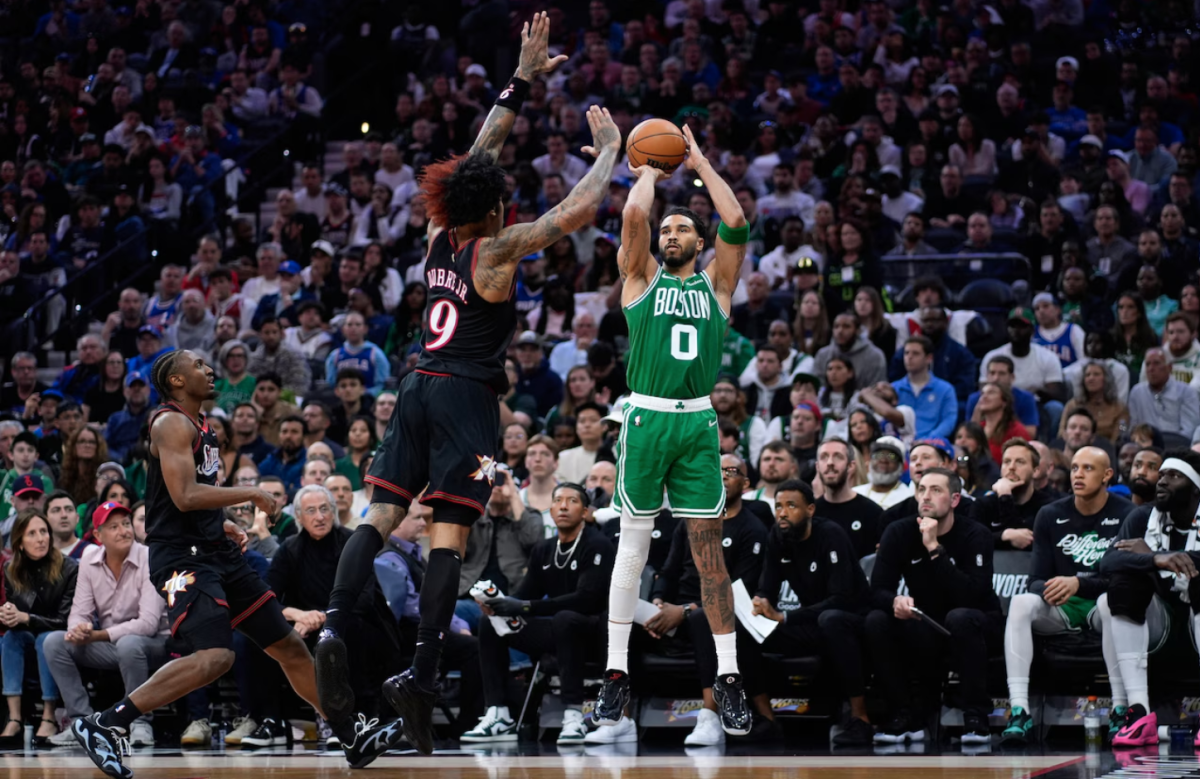 Celtics star player Jayson Tatum rises for a three-point shot over Kelly Oubre Jr. of the 76ers.
