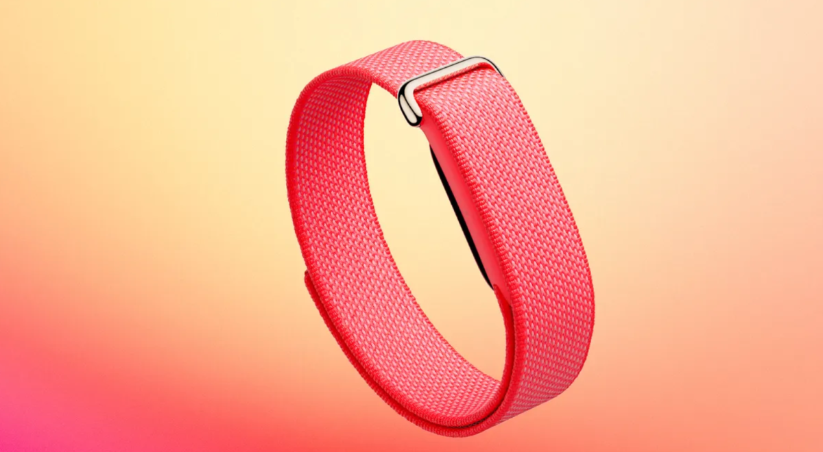 The all-new Fitbit Air, pictured in the pink color of the “Active Band.” The device itself is the slim black rectangle, barely perceivable on the underside of the band.
