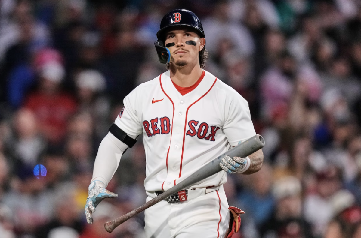 Red Sox Outfielder Jarren Duran is off to a struggling start to the season, as shown through his disappointed expression walking off the field after an at bat.