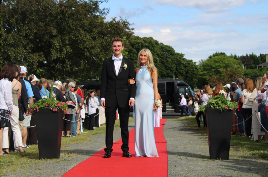 Seniors Paige McManus and Harborlight Business Mananger Will Carr make their way down the red carpet.