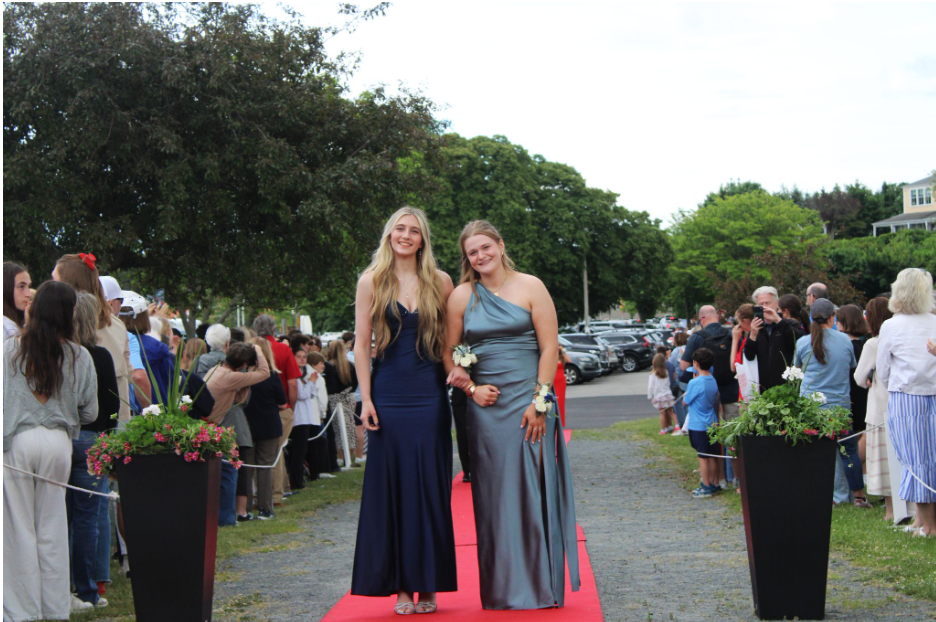 Seniors Alexa Harris and Harborlight Managing Editior Anna Post make their way down the red carpet. 