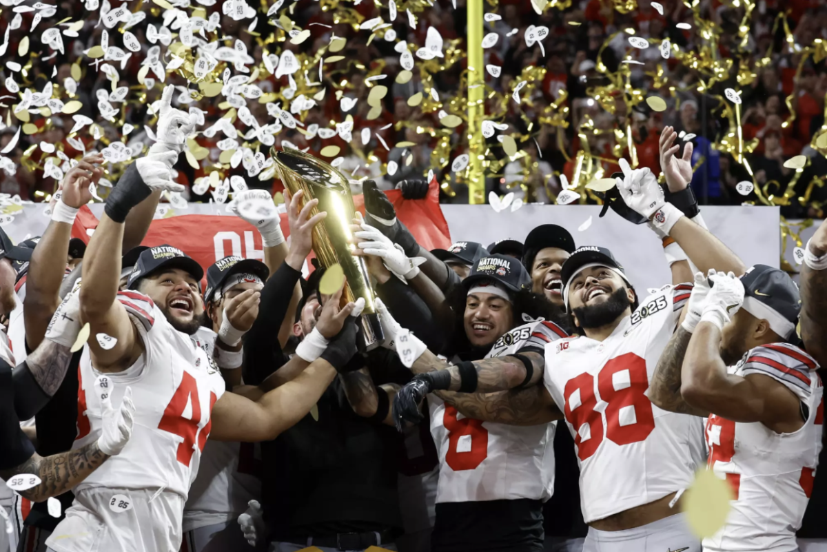 Ohio State Football players JT Tuimoloau (Left), Lathan Ransom (Middle), and Gee Scott Jr. (Right) team celebrate their 34-23 victory over Notre Dame in the 2025 College Football Playoff National Championship. 