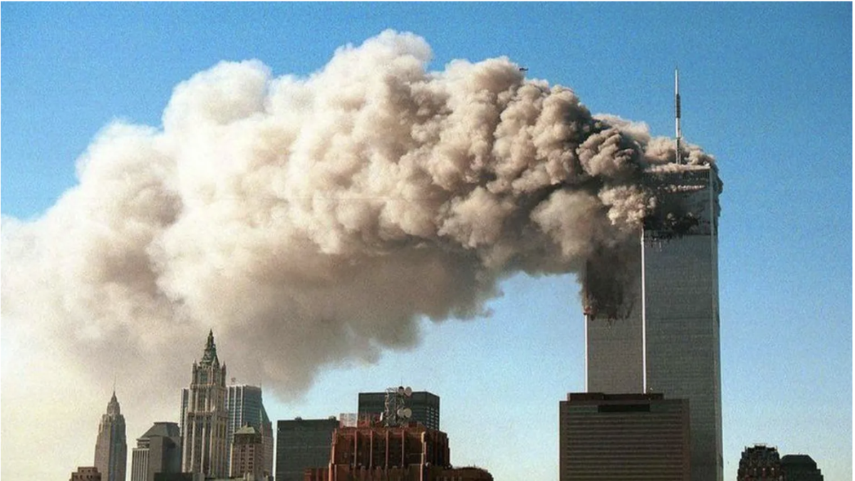 Minutes after the second tower was hit debris and smoke fills the air as the towers collapse. Photo credit: BBC