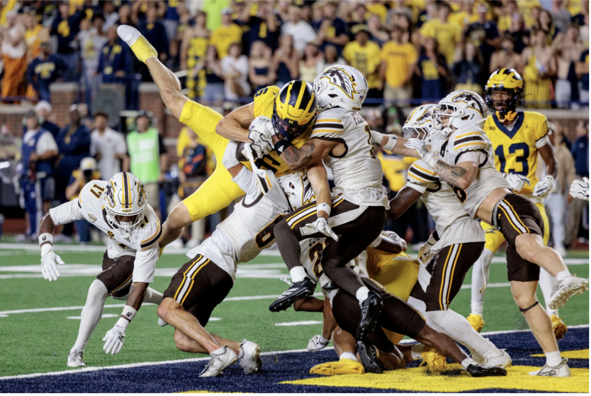 Michigan WR J.J. Buchanan catches a hail mary to win the game against Western Michigan (Photo by: Jacob Hamilton).