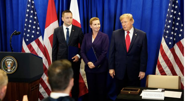 The three signatories agree on the terms of the deal. Credit: Mads Claus Rasmussen
