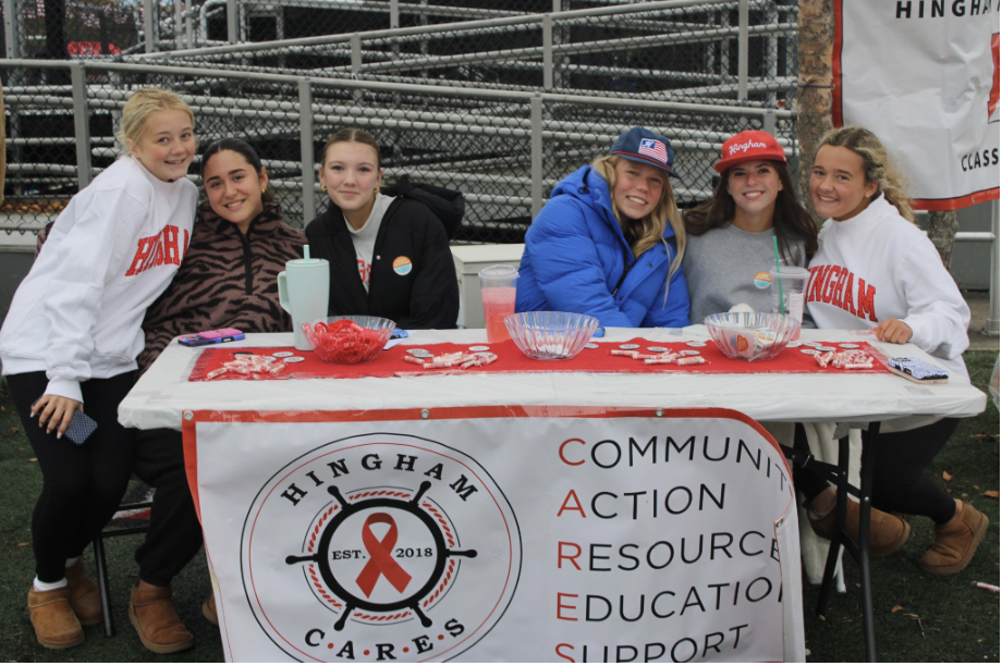 Students pose in front of the Hingham Cares table, advocating against destructive decisions. 