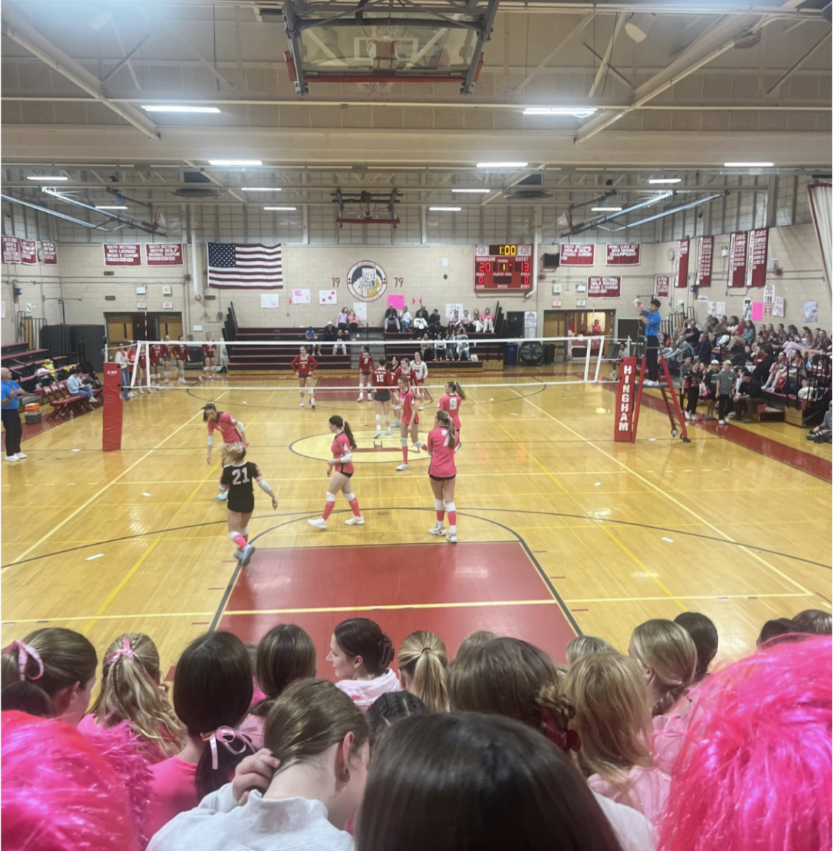 Hingham Girls Volleyball team resetting after winning a battle for a point.